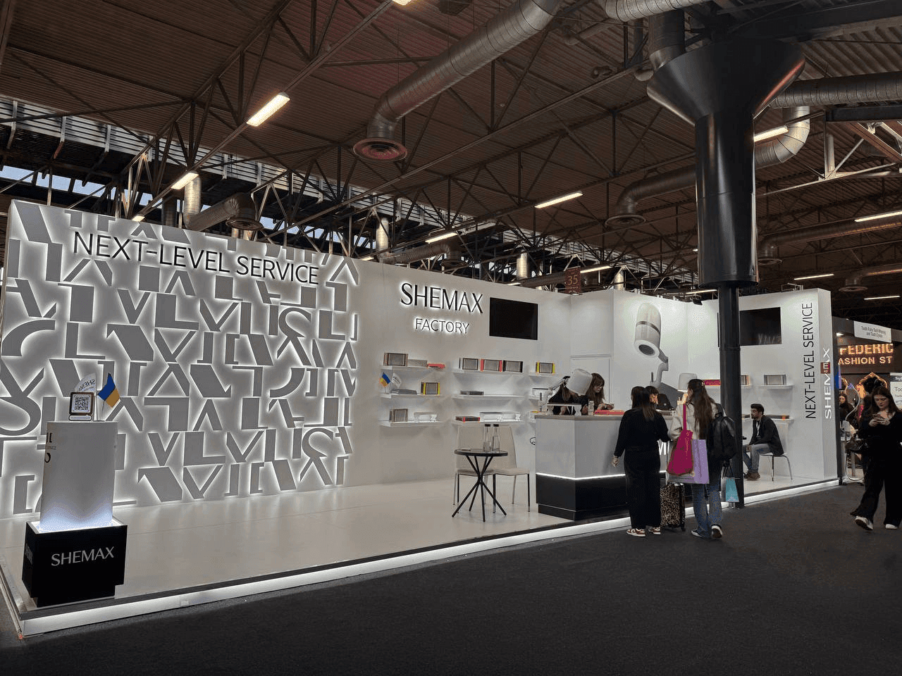 Trade show booth with large white letters spelling out